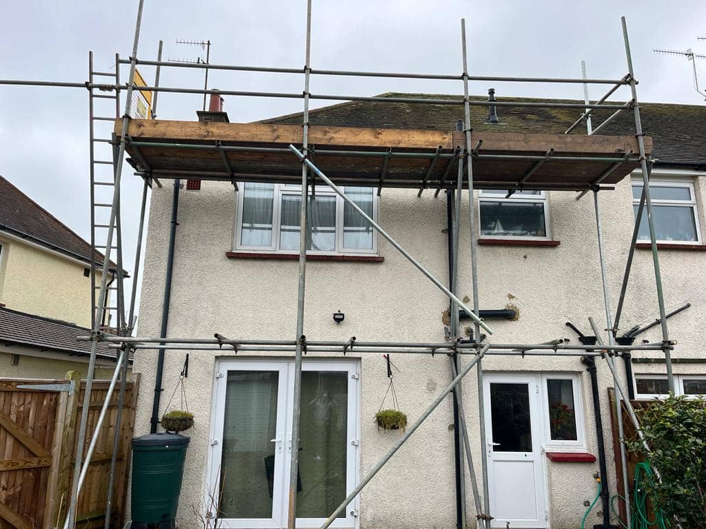 UK detached house with scaffolding during roof work